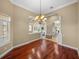 Open-concept dining room boasts hardwood floors, neutral walls, and seamless flow to adjacent living spaces at 13854 Thoroughbred Dr, Dade City, FL 33525