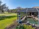 Beautiful landscaping surrounds screened-in pool and patio of the home at 13854 Thoroughbred Dr, Dade City, FL 33525