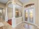 Grand foyer with high ceilings, tile flooring, and elegant entry doors at 13854 Thoroughbred Dr, Dade City, FL 33525