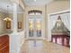 Bright foyer with tile floor, mosaic tile and chandelier at 13854 Thoroughbred Dr, Dade City, FL 33525