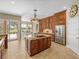 Bright kitchen with stainless steel refrigerator, island, and custom cabinetry at 13854 Thoroughbred Dr, Dade City, FL 33525