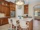 Kitchen island with seating, granite countertops, and custom lighting at 13854 Thoroughbred Dr, Dade City, FL 33525