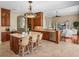 Open concept kitchen flowing into living area with bar seating and stainless appliances at 13854 Thoroughbred Dr, Dade City, FL 33525