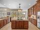 Spacious kitchen with large island, custom cabinets, and views of backyard at 13854 Thoroughbred Dr, Dade City, FL 33525