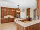 Gourmet kitchen featuring custom cabinets, a center island, and stainless steel appliances at 13854 Thoroughbred Dr, Dade City, FL 33525