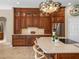 Kitchen with island and seating, custom cabinets, and stainless steel appliances at 13854 Thoroughbred Dr, Dade City, FL 33525