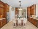 Open kitchen with a large island, bar seating, and custom wood cabinetry at 13854 Thoroughbred Dr, Dade City, FL 33525