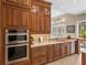Gourmet kitchen with stainless steel appliances and custom wood cabinetry at 13854 Thoroughbred Dr, Dade City, FL 33525