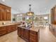 Gourmet kitchen with center island, custom cabinets, and stainless steel appliances at 13854 Thoroughbred Dr, Dade City, FL 33525