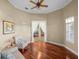 Cozy sitting room featuring hardwood floors, a ceiling fan, and a doorway leading to other living spaces at 13854 Thoroughbred Dr, Dade City, FL 33525