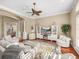 Comfortable living room with plush seating, a fireplace, and a decorative area rug at 13854 Thoroughbred Dr, Dade City, FL 33525