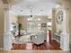 Open-concept living room with decorative columns and large windows at 13854 Thoroughbred Dr, Dade City, FL 33525