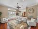 Spacious living room featuring a large window, neutral furniture, and hardwood flooring at 13854 Thoroughbred Dr, Dade City, FL 33525