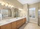 Spacious bathroom with double vanity, large mirror and separate tub and shower at 13854 Thoroughbred Dr, Dade City, FL 33525