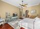 Main bedroom with ceiling fan, area rug, TV, and doorway to the main bathroom at 13854 Thoroughbred Dr, Dade City, FL 33525