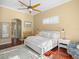 Comfortable bedroom with hardwood floors, soft lighting, and stylish furnishings for a restful retreat at 13854 Thoroughbred Dr, Dade City, FL 33525