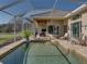 Screened-in pool area with view of outdoor seating, perfect for entertaining at 13854 Thoroughbred Dr, Dade City, FL 33525