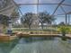 Relaxing backyard pool area with lush greenery and a view of the golf course at 13854 Thoroughbred Dr, Dade City, FL 33525