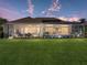 Beautiful backyard featuring a screened-in pool and manicured lawn, perfect for outdoor entertaining and relaxation at 13854 Thoroughbred Dr, Dade City, FL 33525