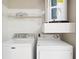 Clean laundry area with a washer and dryer, complemented by overhead storage and a functional setup at 1910 E Palm Ave # 10301, Tampa, FL 33605