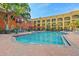 Large swimming pool with lounge chairs, umbrellas, and views of the surrounding buildings at 1910 E Palm Ave # 10301, Tampa, FL 33605