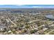 Expansive aerial view of a residential neighborhood featuring tree-lined streets and tranquil lakes at 1937 Palm Dr, Clearwater, FL 33763