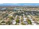 This neighborhood aerial view shows the community's layout, complete with lake views, mature trees, and a serene setting at 1937 Palm Dr, Clearwater, FL 33763