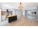 An open kitchen features stainless steel appliances, a breakfast bar, and wood open shelves at 1937 Palm Dr, Clearwater, FL 33763