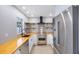 A bright kitchen featuring butcher block countertops, stainless appliances, and open shelving at 1937 Palm Dr, Clearwater, FL 33763