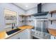 Beautiful kitchen featuring butcher block countertops, stainless steel appliances, and open shelving at 1937 Palm Dr, Clearwater, FL 33763