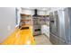 Kitchen featuring stainless steel appliances, wooden countertops, and floating shelves for stylish storage at 1937 Palm Dr, Clearwater, FL 33763