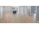 Bright and inviting open-concept space with neutral paint, wood-look tile, and an elegant hanging light fixture at 1937 Palm Dr, Clearwater, FL 33763
