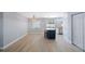 Open-concept living area includes an island, wood-look tile, and a beaded chandelier for a warm atmosphere at 1937 Palm Dr, Clearwater, FL 33763