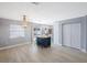 Bright living space with wood-look tile, an island, and a view to the backyard pool through sliding glass doors at 1937 Palm Dr, Clearwater, FL 33763
