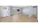 Inviting living room boasts wood-look tile, a large window, and a freshly painted neutral color palette at 1937 Palm Dr, Clearwater, FL 33763
