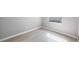 An empty room with wood-look floors, neutral walls, and a window with natural light at 1937 Palm Dr, Clearwater, FL 33763