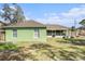 This backyard features an enclosed sunroom and mature landscaping at 2259 Renton Ln, Spring Hill, FL 34609