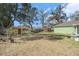 Large backyard featuring mature landscaping, storage shed and mature trees at 2259 Renton Ln, Spring Hill, FL 34609