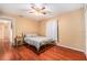This bedroom features wood flooring, a ceiling fan, and a comfortable bed at 2259 Renton Ln, Spring Hill, FL 34609