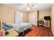 Cozy bedroom with wood floors, neutral walls, a ceiling fan, and a double closet at 2259 Renton Ln, Spring Hill, FL 34609