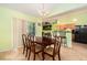 Bright dining room with a chandelier, a large dining table, and sliding glass doors to a screened patio at 2259 Renton Ln, Spring Hill, FL 34609