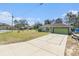 Long driveway leading to the home, showcasing its well-kept lawn and mature trees at 2259 Renton Ln, Spring Hill, FL 34609