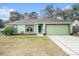Charming single-story home featuring a well-maintained lawn and a two-car garage at 2259 Renton Ln, Spring Hill, FL 34609