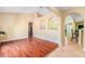Open-concept living room with hardwood floors and arched doorways to the dining area at 2259 Renton Ln, Spring Hill, FL 34609