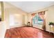 Bright living room featuring hardwood floors, a vaulted ceiling, and ample natural light at 2259 Renton Ln, Spring Hill, FL 34609
