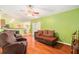 Cozy living area with hardwood floors, a ceiling fan, and comfortable seating at 2259 Renton Ln, Spring Hill, FL 34609