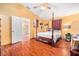The bedroom features wood floors, a four-poster bed, and a doorway leading to another room at 2259 Renton Ln, Spring Hill, FL 34609
