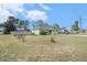 Expansive front yard with a view of the home, driveway, and surrounding greenery at 2259 Renton Ln, Spring Hill, FL 34609