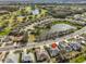 Scenic aerial view showcases neighborhood with ponds, golf course, and mature landscaping at 2449 E Del Webb Blvd, Sun City Center, FL 33573