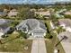 Aerial shot highlighting the property with a well-manicured lawn and mature palm trees at 2449 E Del Webb Blvd, Sun City Center, FL 33573